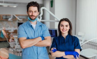 portrait smiling dentist standing